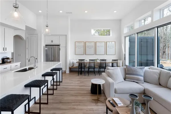 a kitchen with refrigerator a sink and chairs