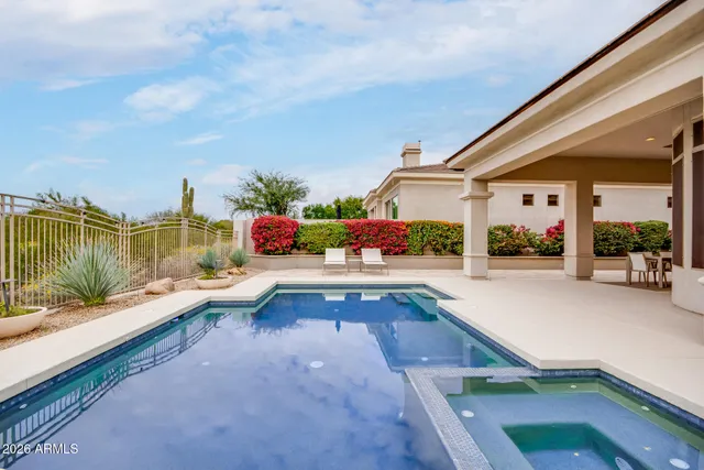 a front view of a house with a garden and plants