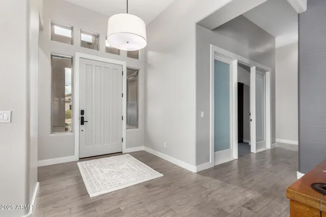a bedroom with a bed and a large window