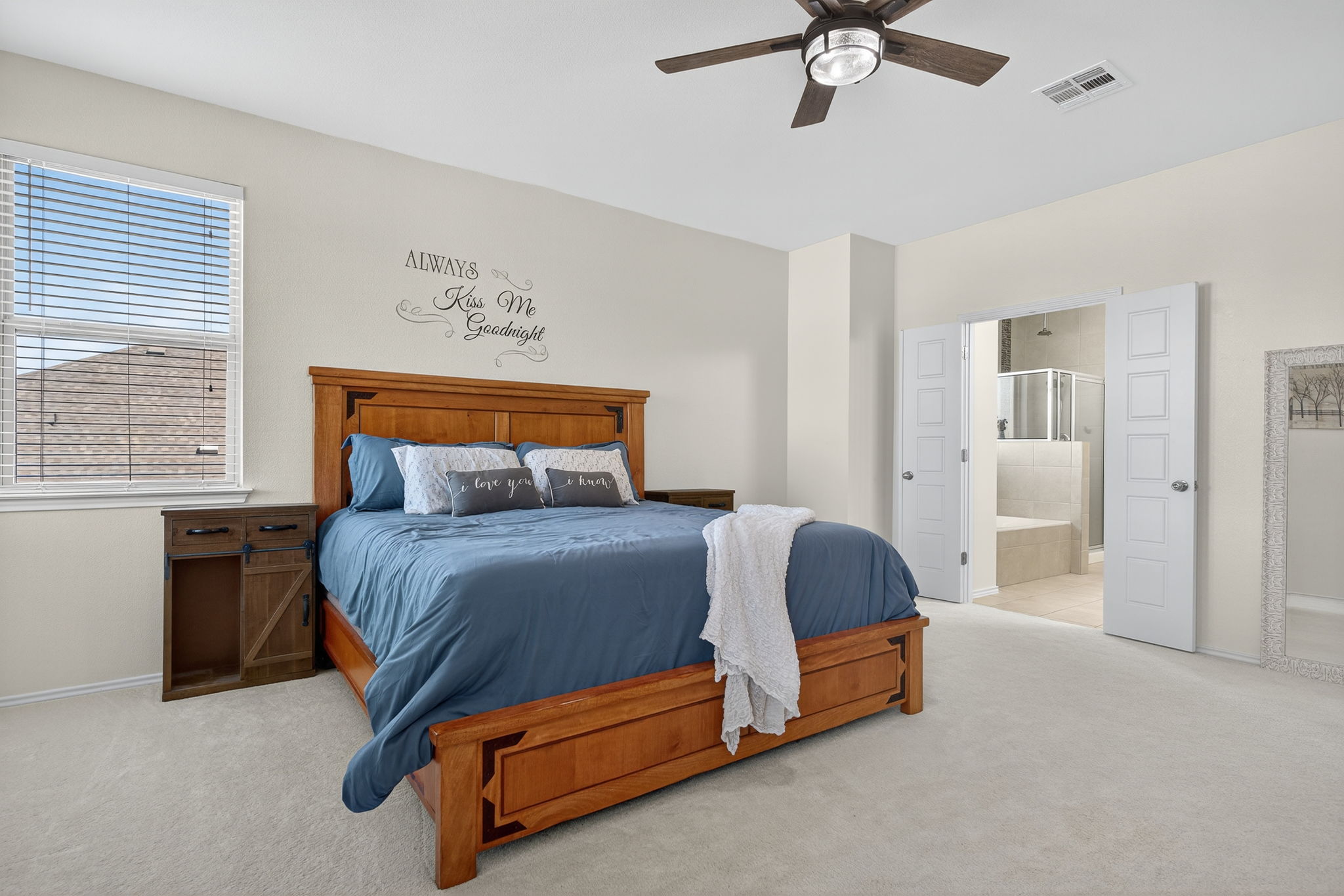 13300 Craven Lane Manor, TX 78653 - Photo 14 of 40 Primary Bedroom featuring high-end carpet floors, ceiling fan, and an ensuite bathroom with French doors
