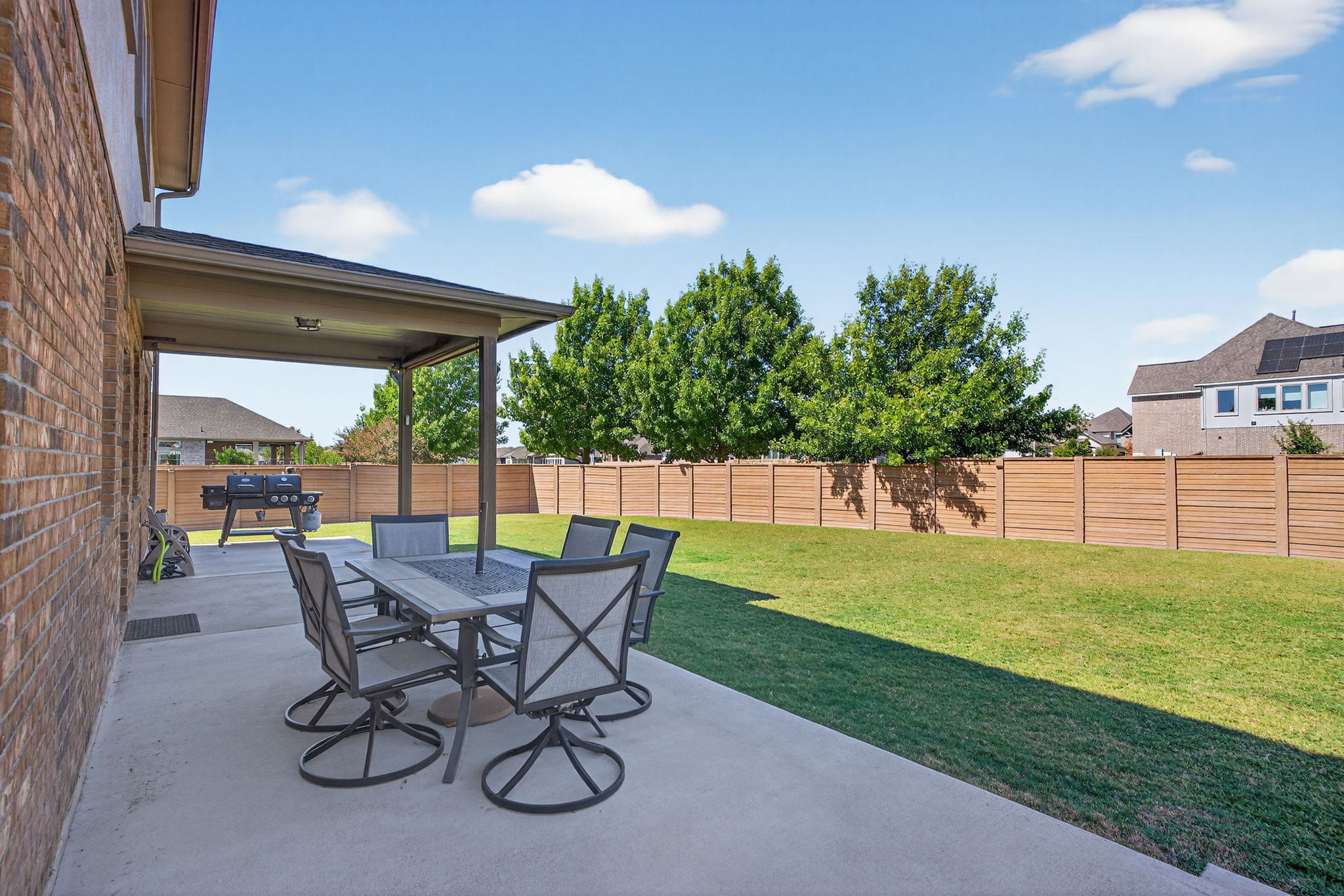 13300 Craven Lane Manor, TX 78653 - Photo 31 of 40 Fenced backyard with a patio and outdoor dining area