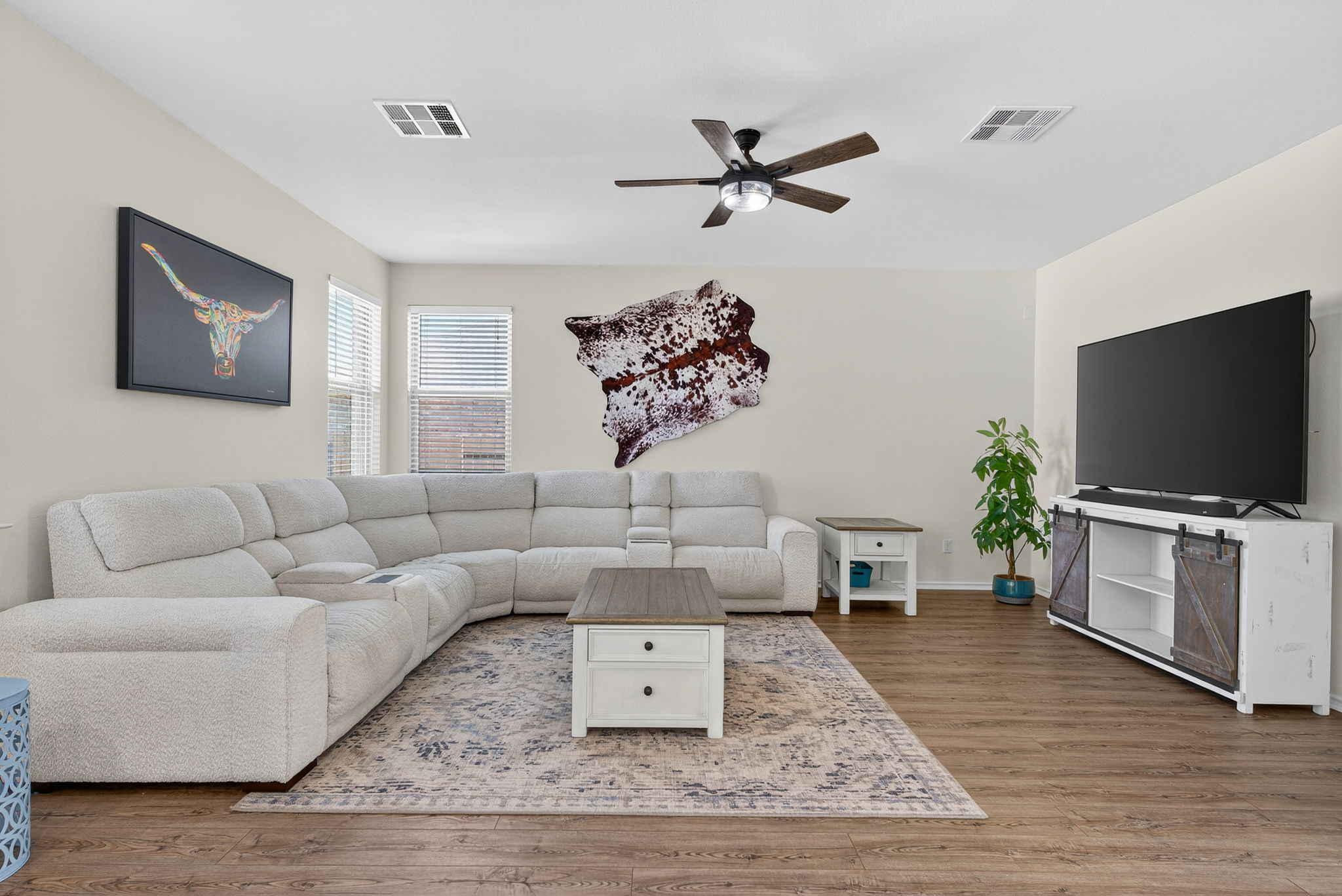 13300 Craven Lane Manor, TX 78653 - Photo 5 of 40 Living room featuring a ceiling fan, natural light and no carpet. Plenty of space for a large sectional, oversized tv and an entertainment center.