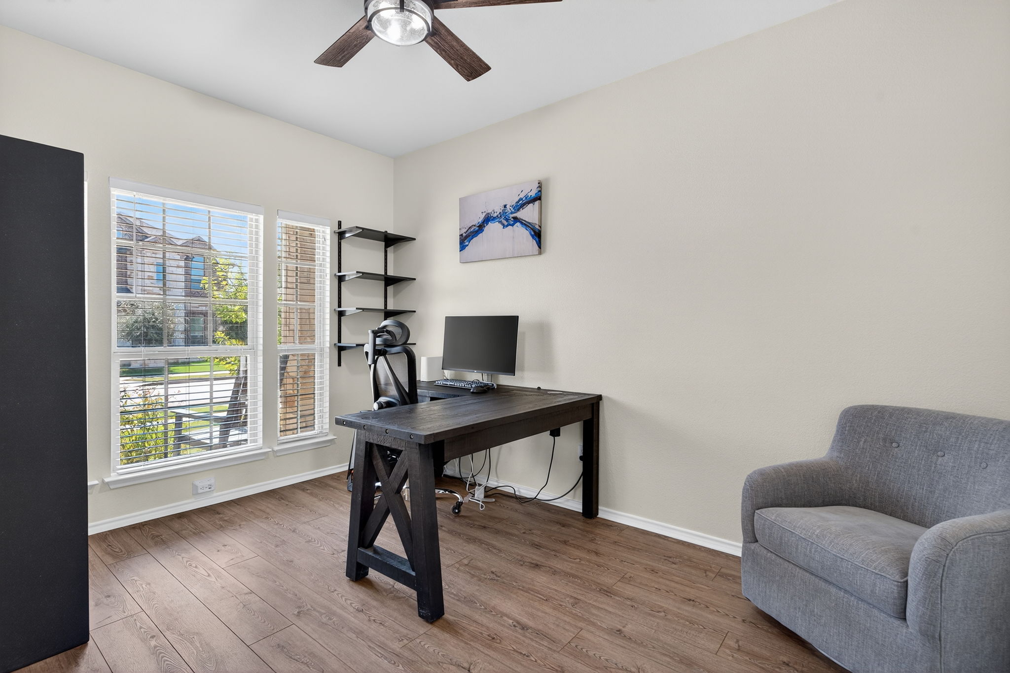 13300 Craven Lane Manor, TX 78653 - Photo 9 of 40 Home office with a ceiling fan, tons of natural light and shelving. The office has solid French doors and is located on the main floor.