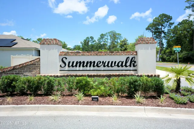 a front view of a house with garden and street