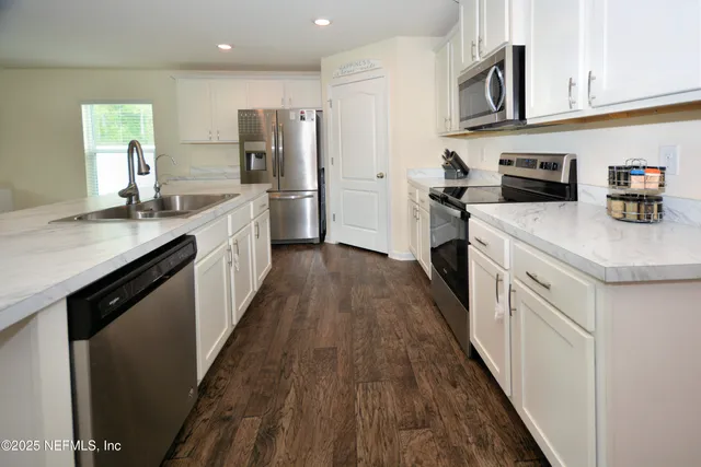 a kitchen with cabinets and stainless steel appliances