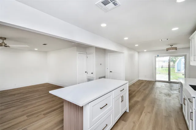 a view of a kitchen counter space and wooden floor