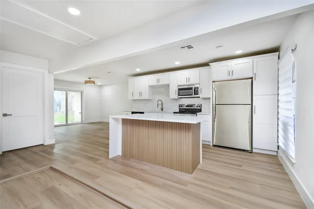 a kitchen with a refrigerator and a sink