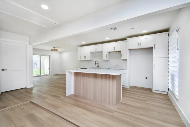 a large kitchen with a sink dishwasher a stove and a refrigerator