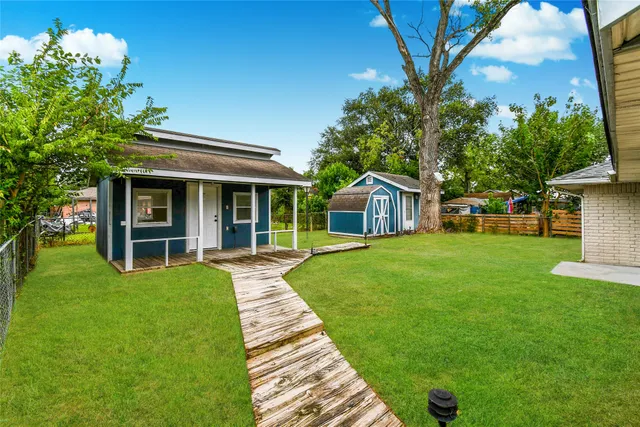 a view of a house with a yard porch and sitting area