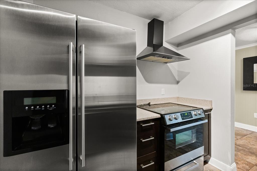 2500 Lee Road, Unit 122 Winter Park, FL 32789 - Photo 11 of 25 a kitchen with a stove and a refrigerator