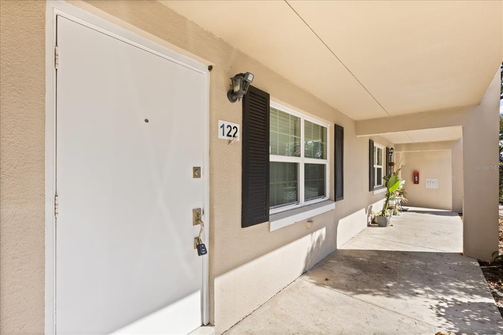 2500 Lee Road, Unit 122 Winter Park, FL 32789 - Photo 3 of 25 a view of a hallway with wooden floor and a door