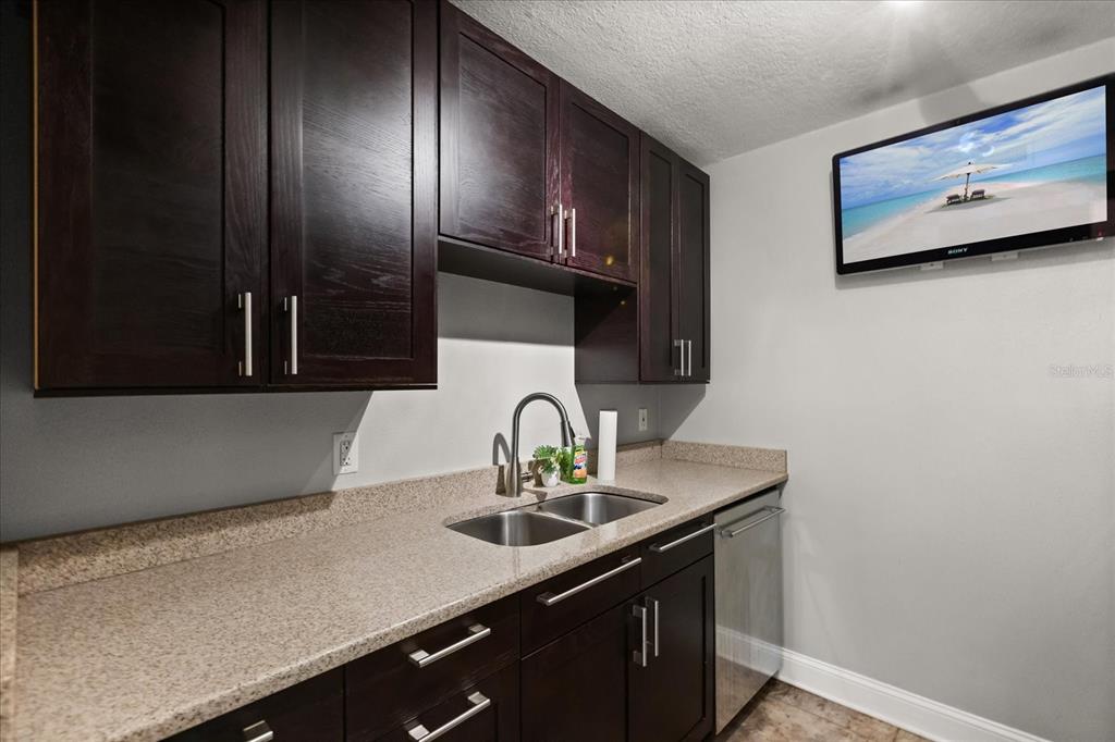 2500 Lee Road, Unit 122 Winter Park, FL 32789 - Photo 9 of 25 a kitchen with a sink cabinets and stainless steel appliances