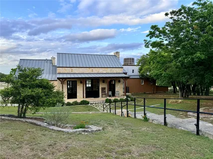 a view of a house with sitting area and a yard
