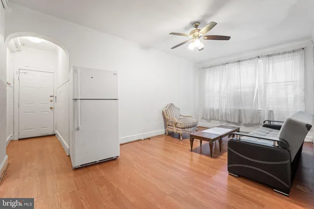 a work room with furniture and a ceiling fan