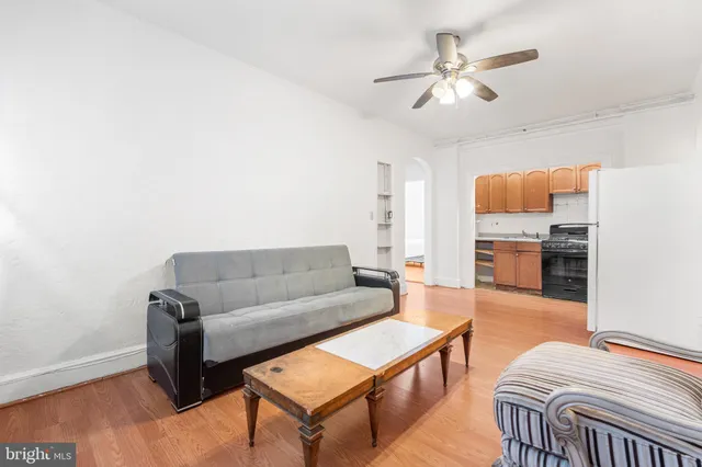a living room with furniture a ceiling fan and a rug