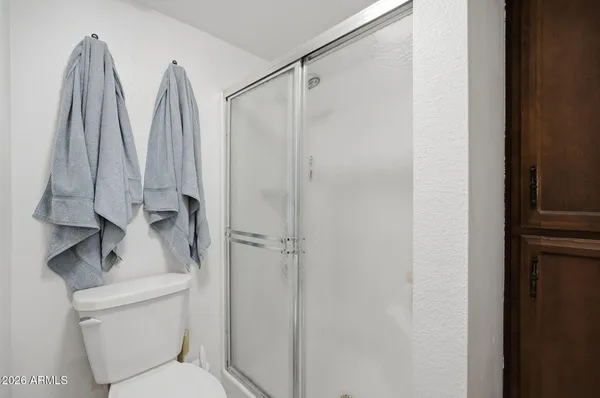 a bathroom with a shower and toilet