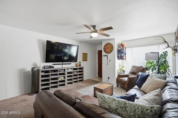 a living room with furniture and a flat screen tv