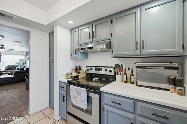 a kitchen with stainless steel appliances granite countertop a stove and a refrigerator