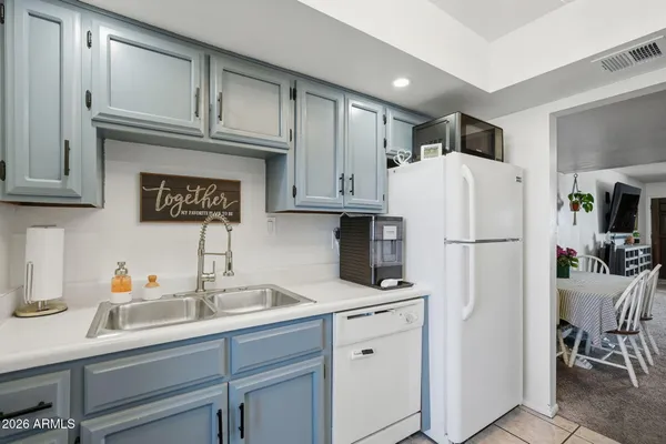 a kitchen with stainless steel appliances granite countertop a refrigerator sink and cabinets