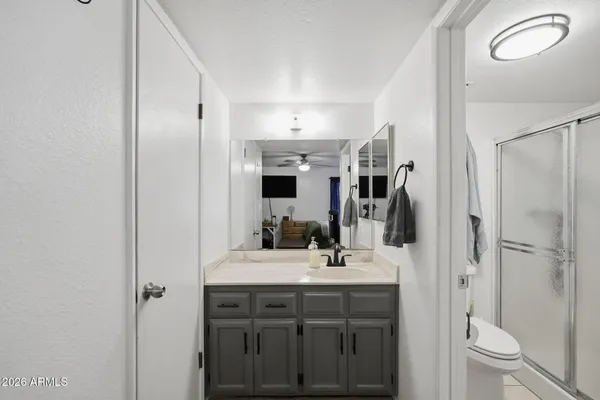 a bathroom with a sink toilet double vanity and tub