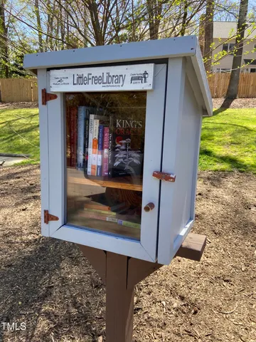 a view of a wooden house with a sign on it