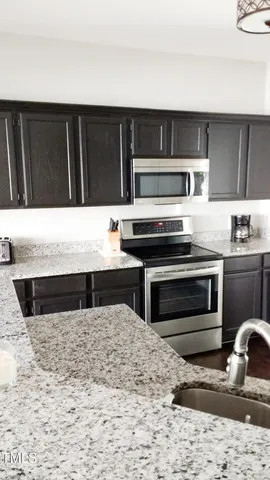 a view of kitchen with microwave and stove
