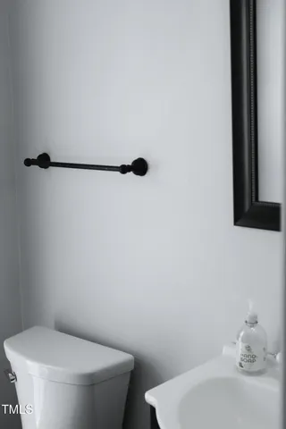 a white toilet sitting next to a bathroom sink