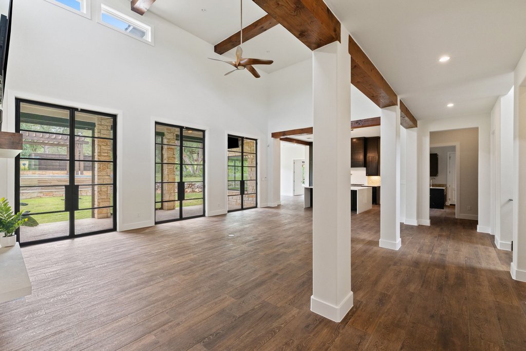 11002 Foundation Road Austin, TX 78726 - Photo 13 of 40 an empty room with wooden floor and windows