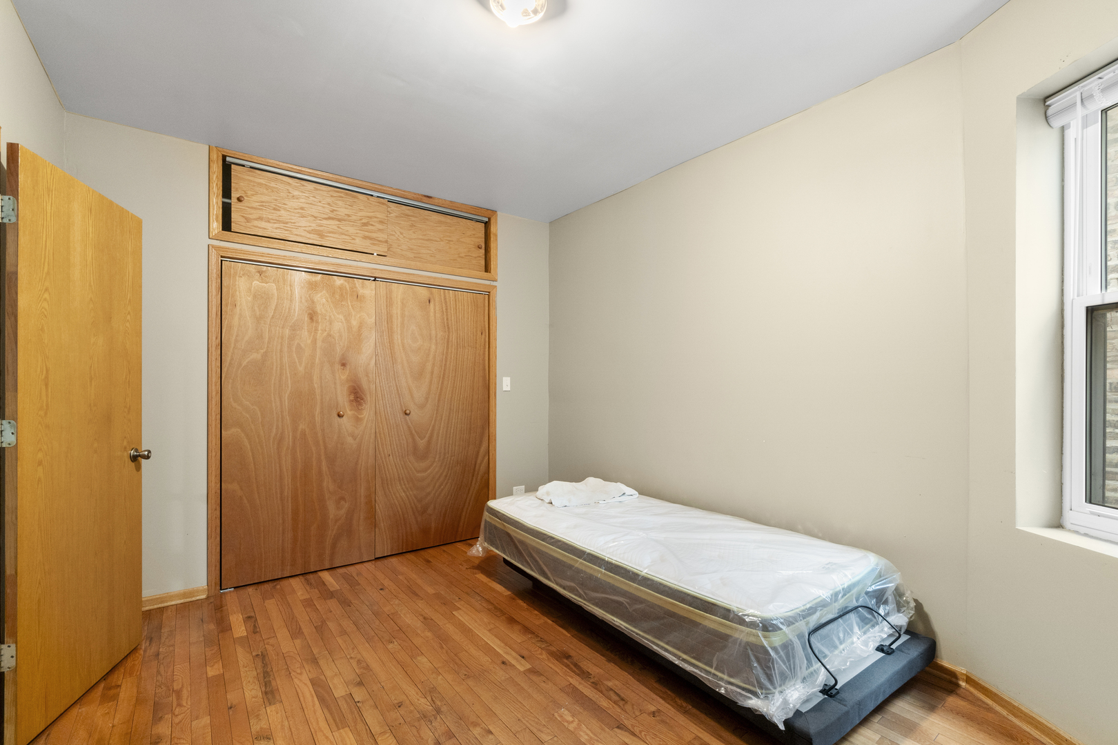 7223 North Damen Avenue Chicago, IL 60645 - Photo 12 of 37 a bedroom with a bed and a window