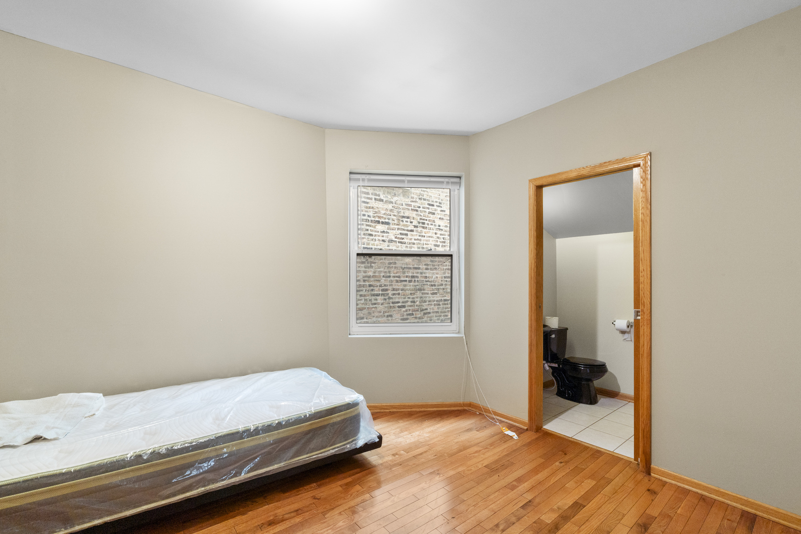 7223 North Damen Avenue Chicago, IL 60645 - Photo 14 of 37 a bedroom with a bed and a window