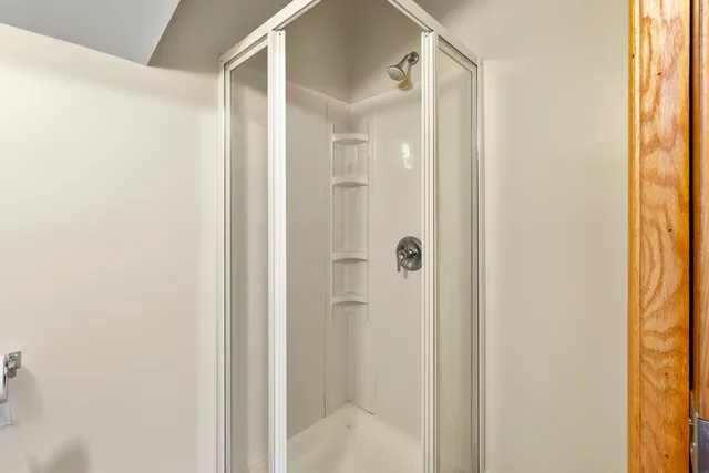 a bathroom with a glass shower door