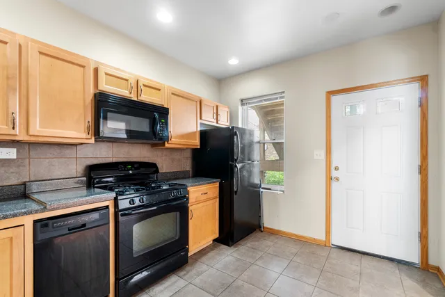 a kitchen with stainless steel appliances granite countertop a refrigerator stove and microwave