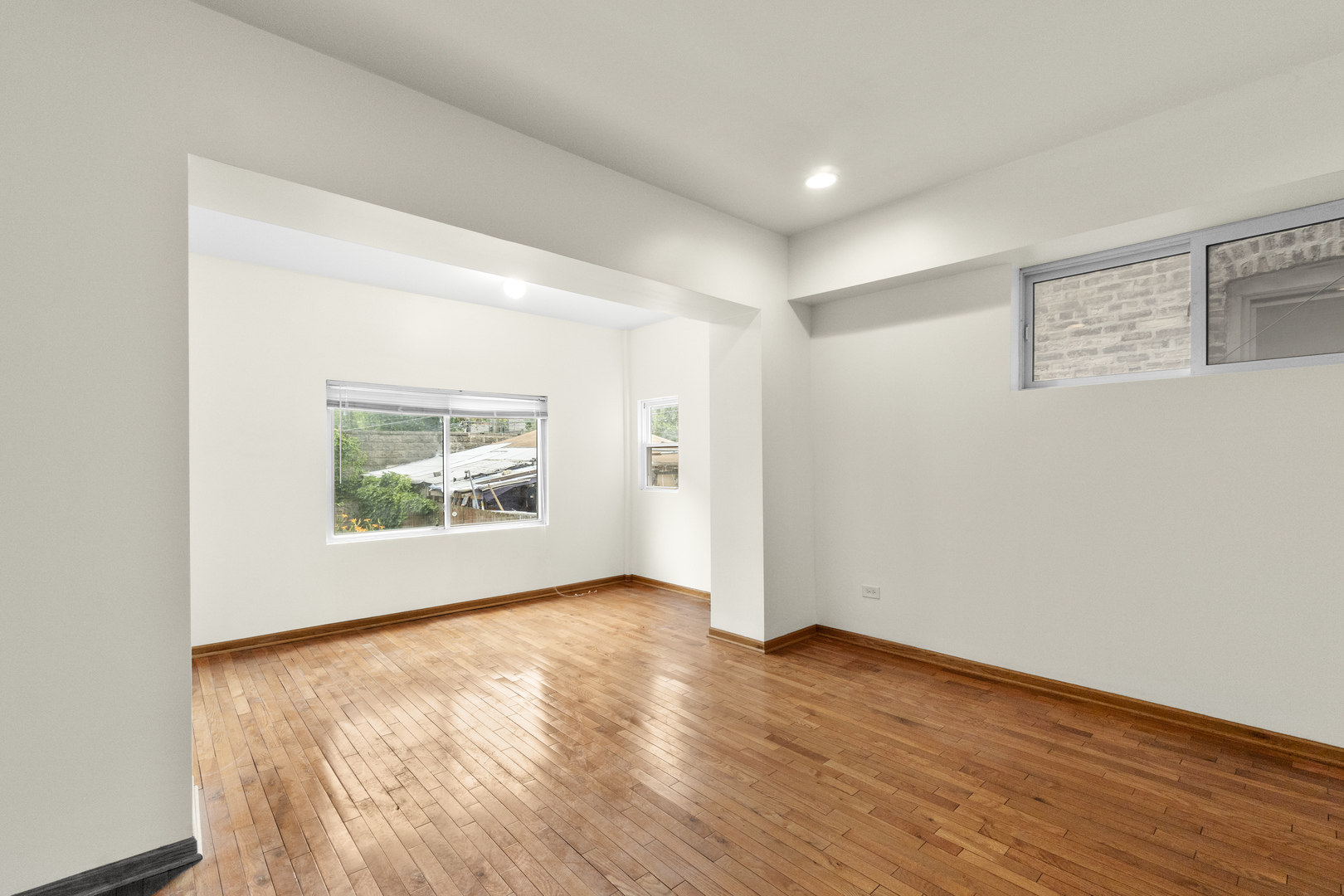 7223 North Damen Avenue Chicago, IL 60645 - Photo 21 of 37 an empty room with wooden floor and window