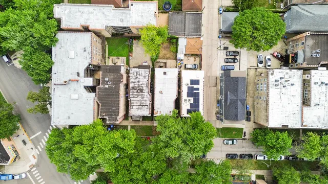 an aerial view of residential houses with outdoor space and street view
