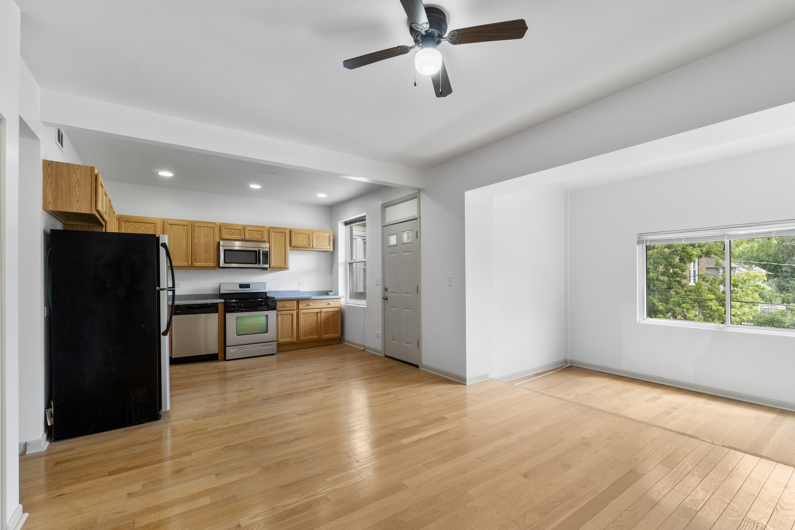 7223 North Damen Avenue Chicago, IL 60645 - Photo 33 of 37 a view of kitchen with stainless steel appliances kitchen island wooden floor and living room view