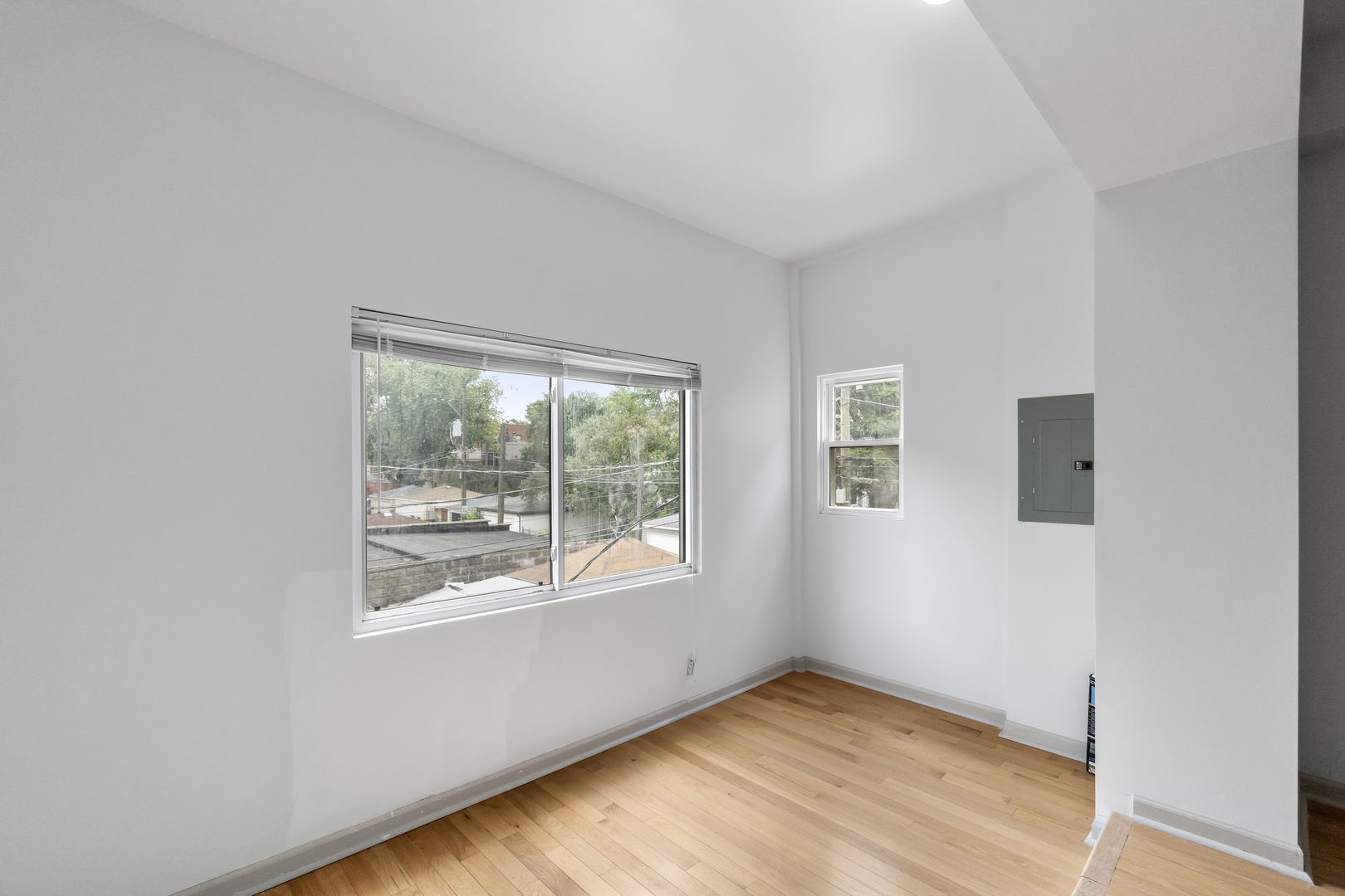 7223 North Damen Avenue Chicago, IL 60645 - Photo 34 of 37 a view of an empty room with wooden floor and a window
