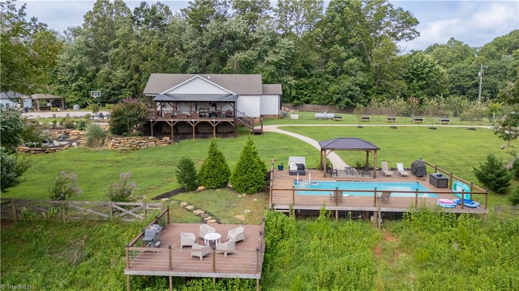 1009 Ray Loop Road Westfield, NC 27053 - Photo 7 of 45 Side view of home overlooking the pool area and other grilling deck