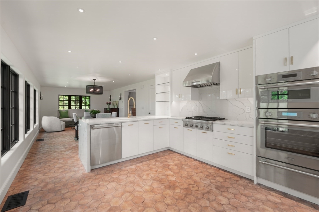 709 Boston Post Road Weston, MA 02493 - Photo 11 of 42 a kitchen with white cabinets and stainless steel appliances