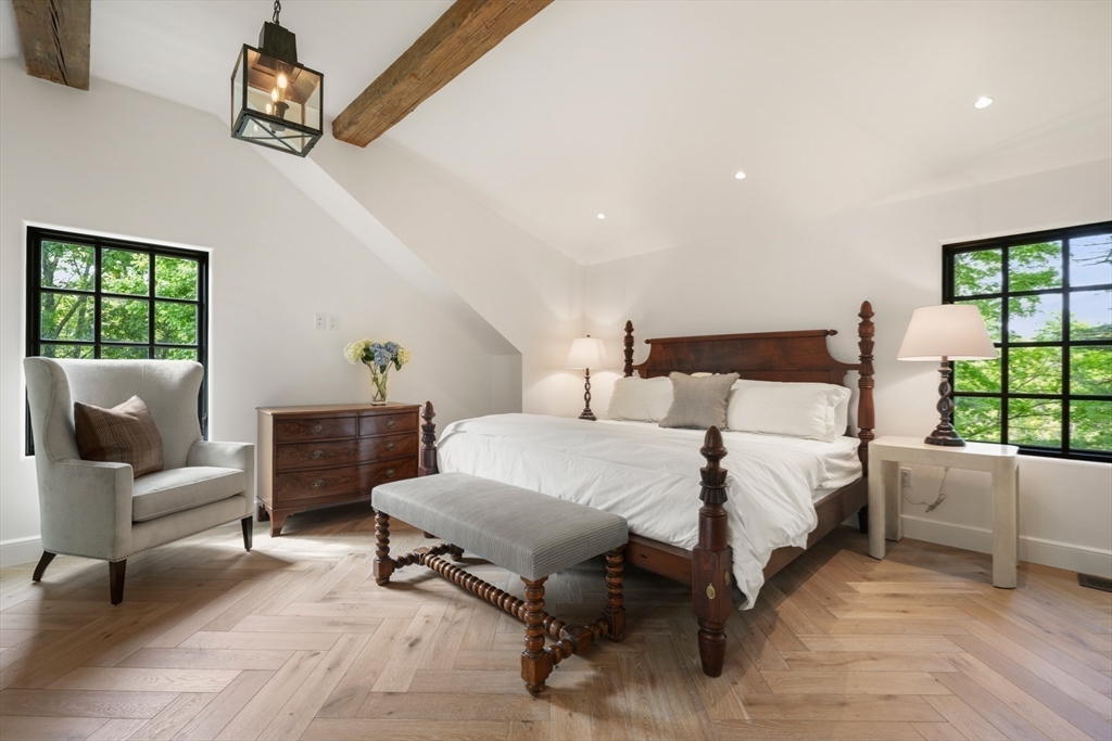 709 Boston Post Road Weston, MA 02493 - Photo 19 of 42 a bedroom with a bed a couch and window