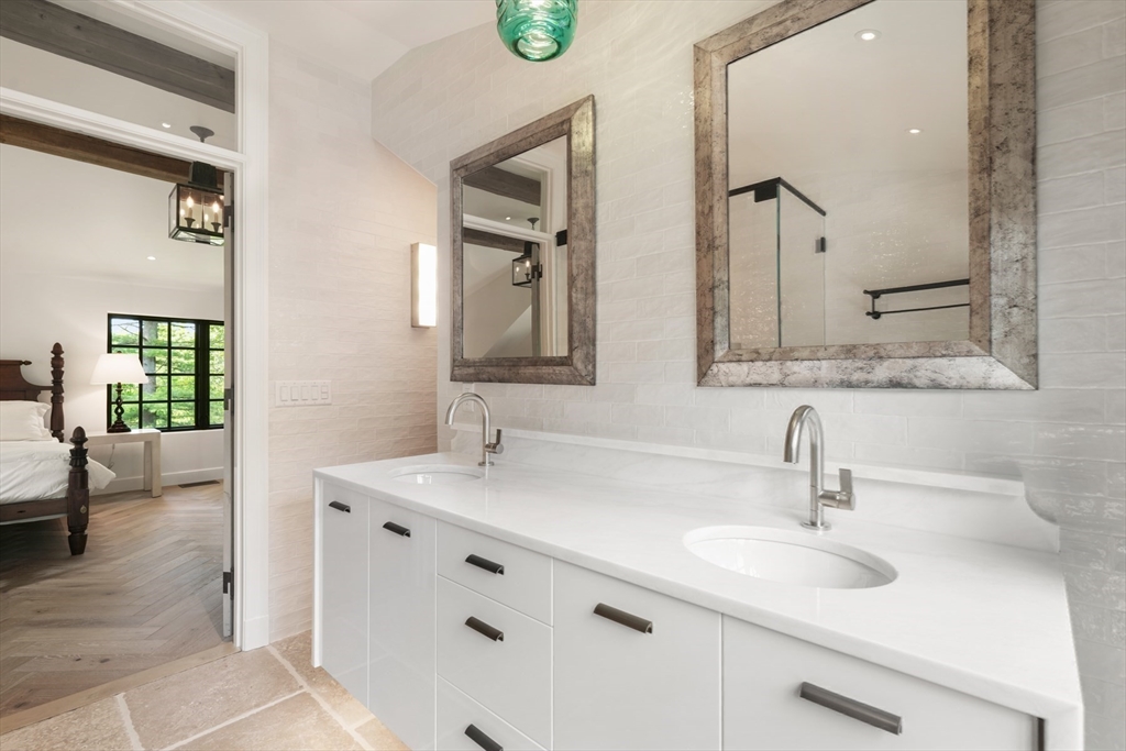709 Boston Post Road Weston, MA 02493 - Photo 20 of 42 a bathroom with a double vanity sink mirror and