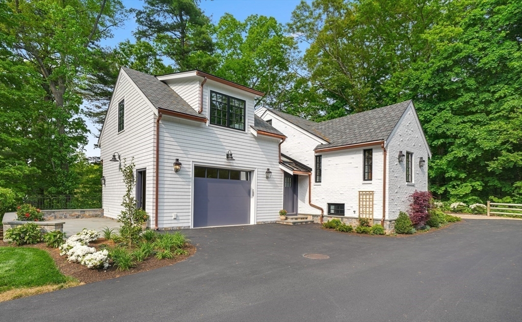 709 Boston Post Road Weston, MA 02493 - Photo 2 of 42 a view of a house with a yard and garage