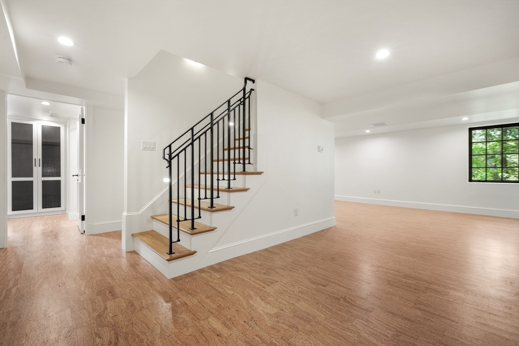 709 Boston Post Road Weston, MA 02493 - Photo 29 of 42 an empty room with wooden floor and windows