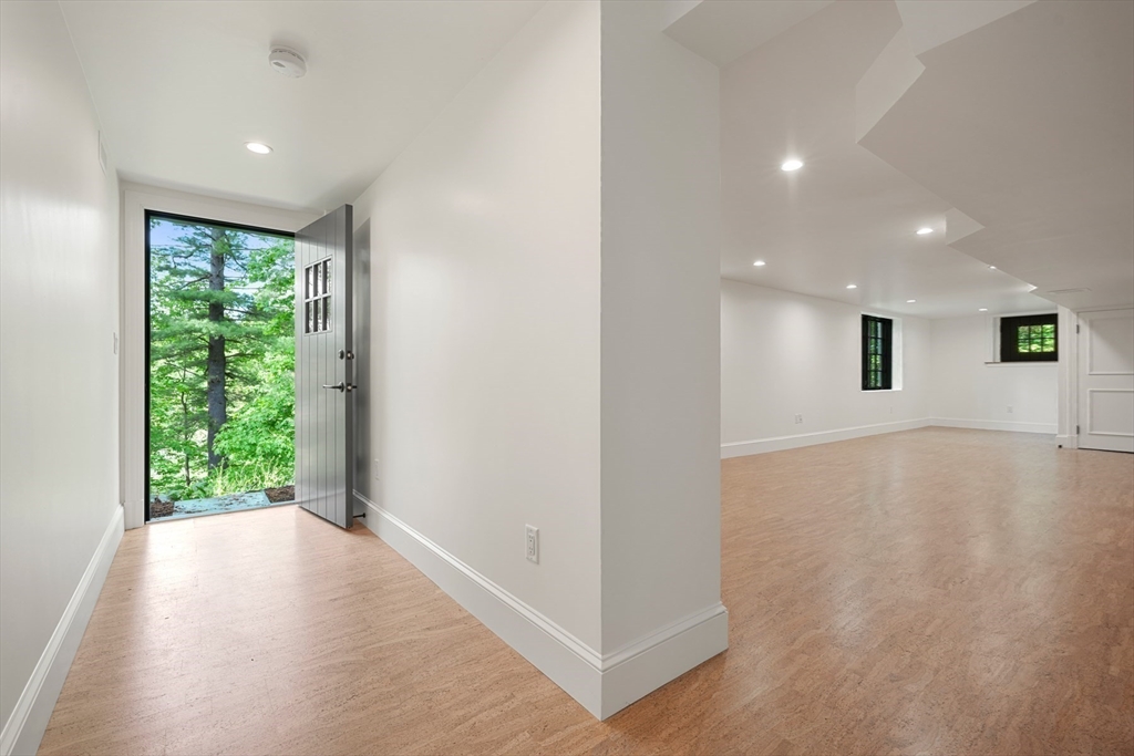 709 Boston Post Road Weston, MA 02493 - Photo 33 of 42 an empty room with wooden floor and windows