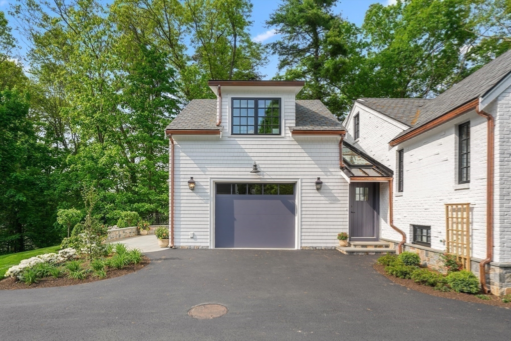 709 Boston Post Road Weston, MA 02493 - Photo 38 of 42 a front view of a house with a yard and garage