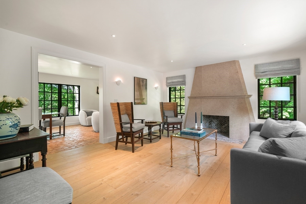 709 Boston Post Road Weston, MA 02493 - Photo 4 of 42 a living room with furniture a fireplace and a floor to ceiling window