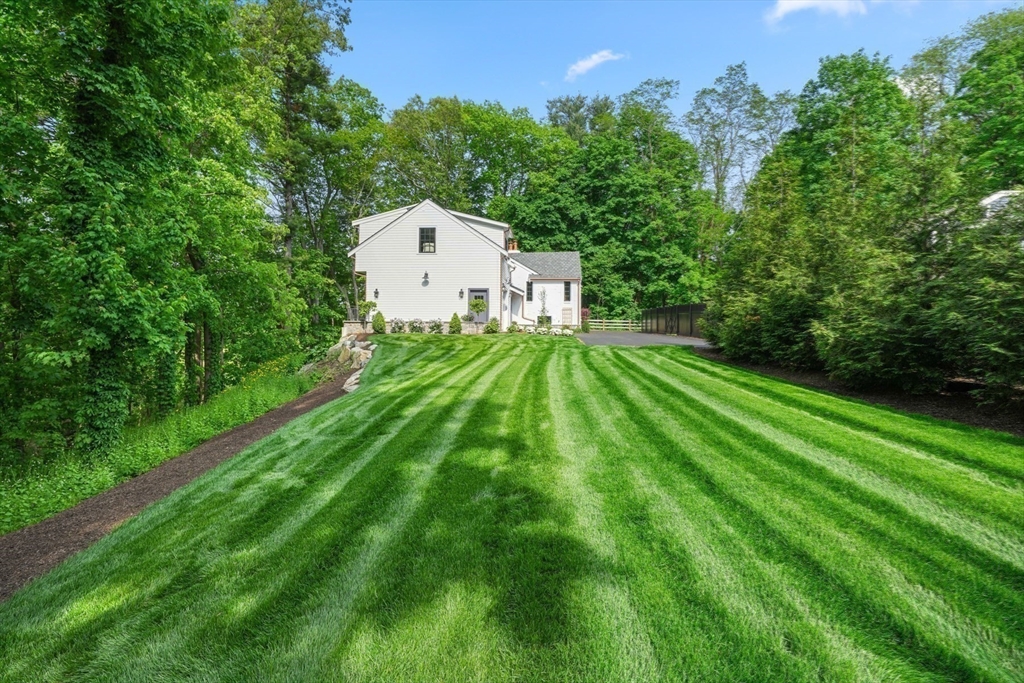 709 Boston Post Road Weston, MA 02493 - Photo 42 of 42 a backyard of a house with lots of green space and trees all around
