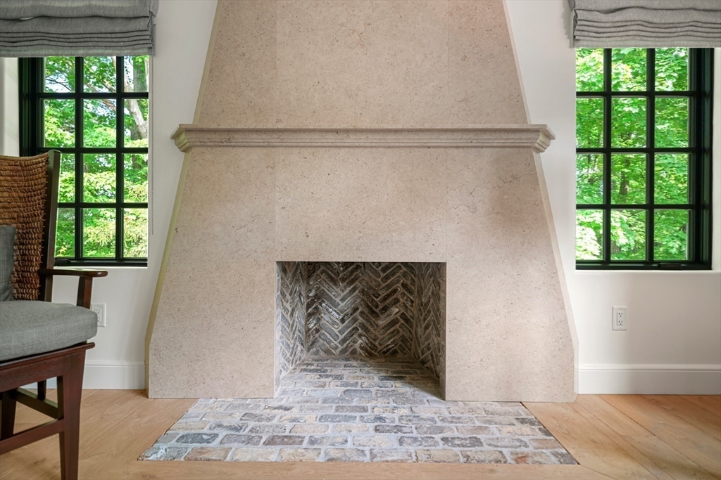 709 Boston Post Road Weston, MA 02493 - Photo 5 of 42 a living room with a fireplace and a window