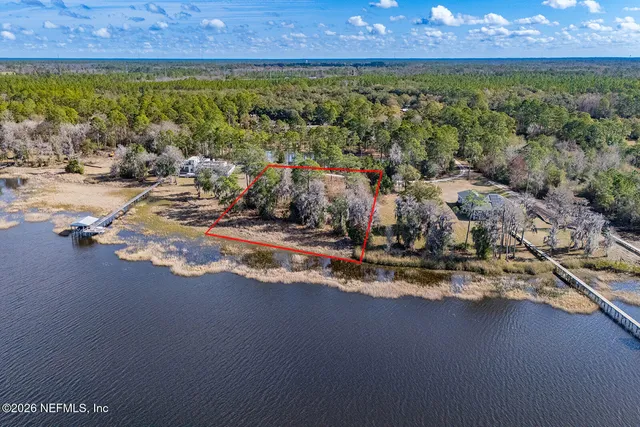 a view of a yard with wooden fence