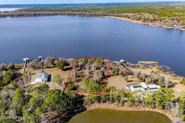 a aerial view of a house with a lake view