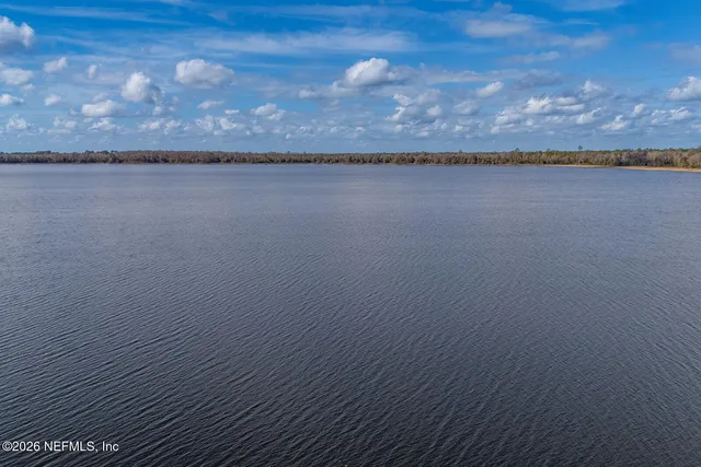 an aerial view of a house with a lake view